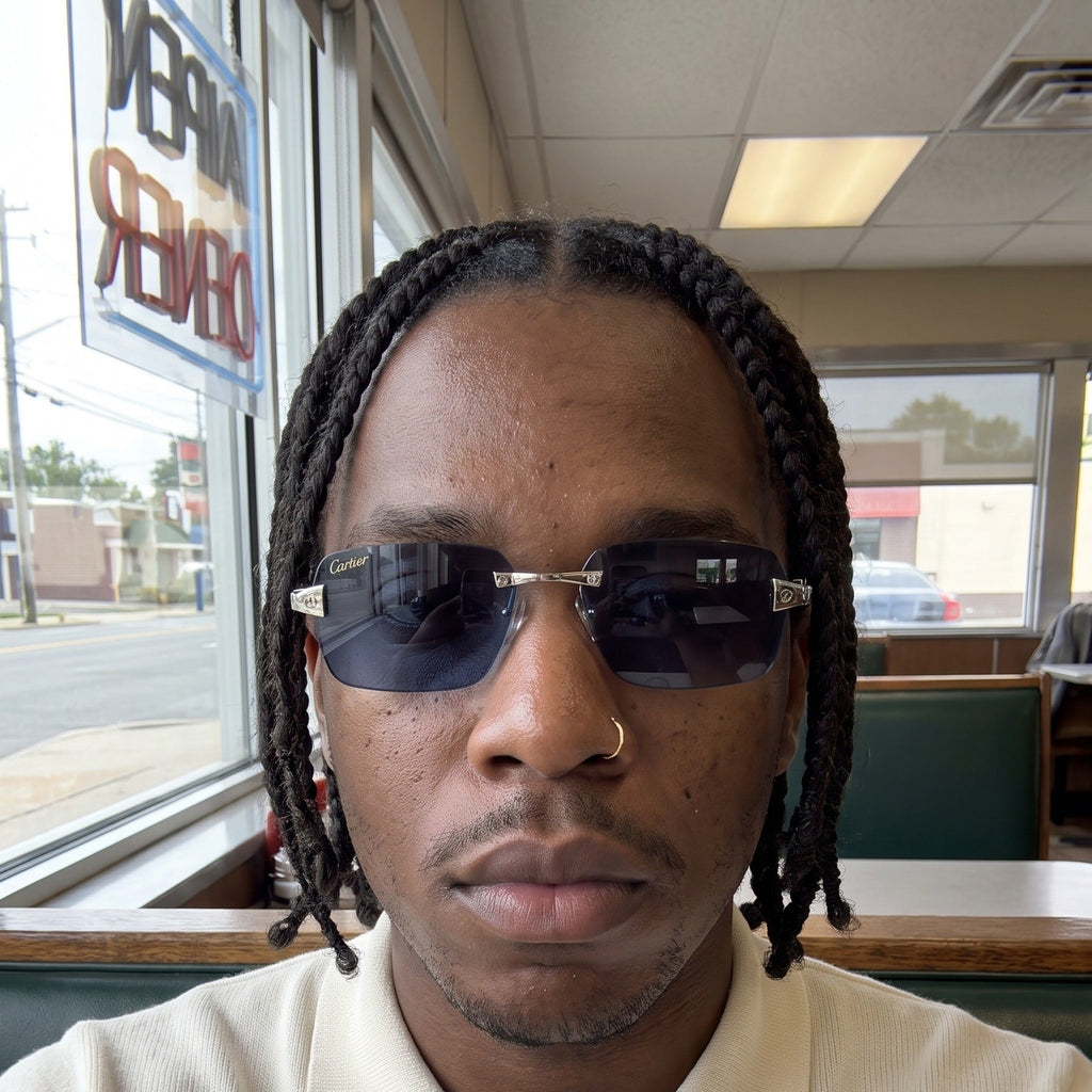 Man wearing the Big C Wires, solid blue lenses, Cartier eyewear