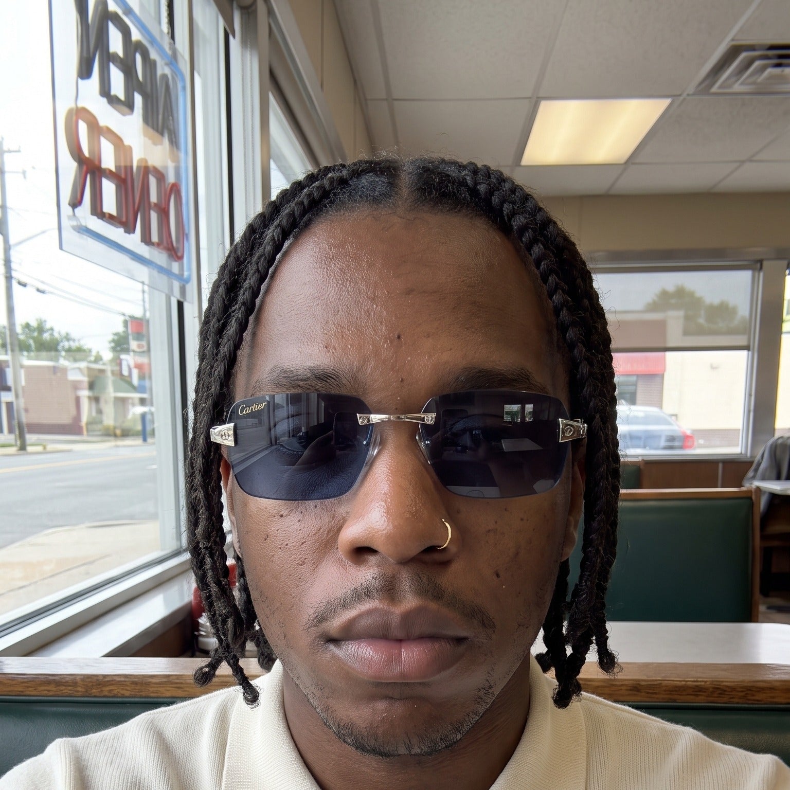 Man wearing the Big C Wires, solid blue lenses, Cartier eyewear