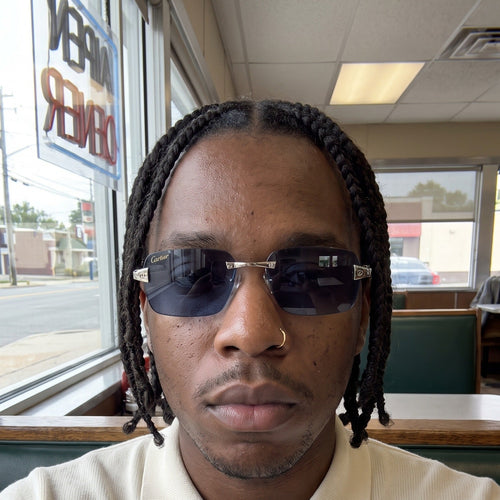 Man wearing the Big C Wires, solid blue lenses, Cartier eyewear