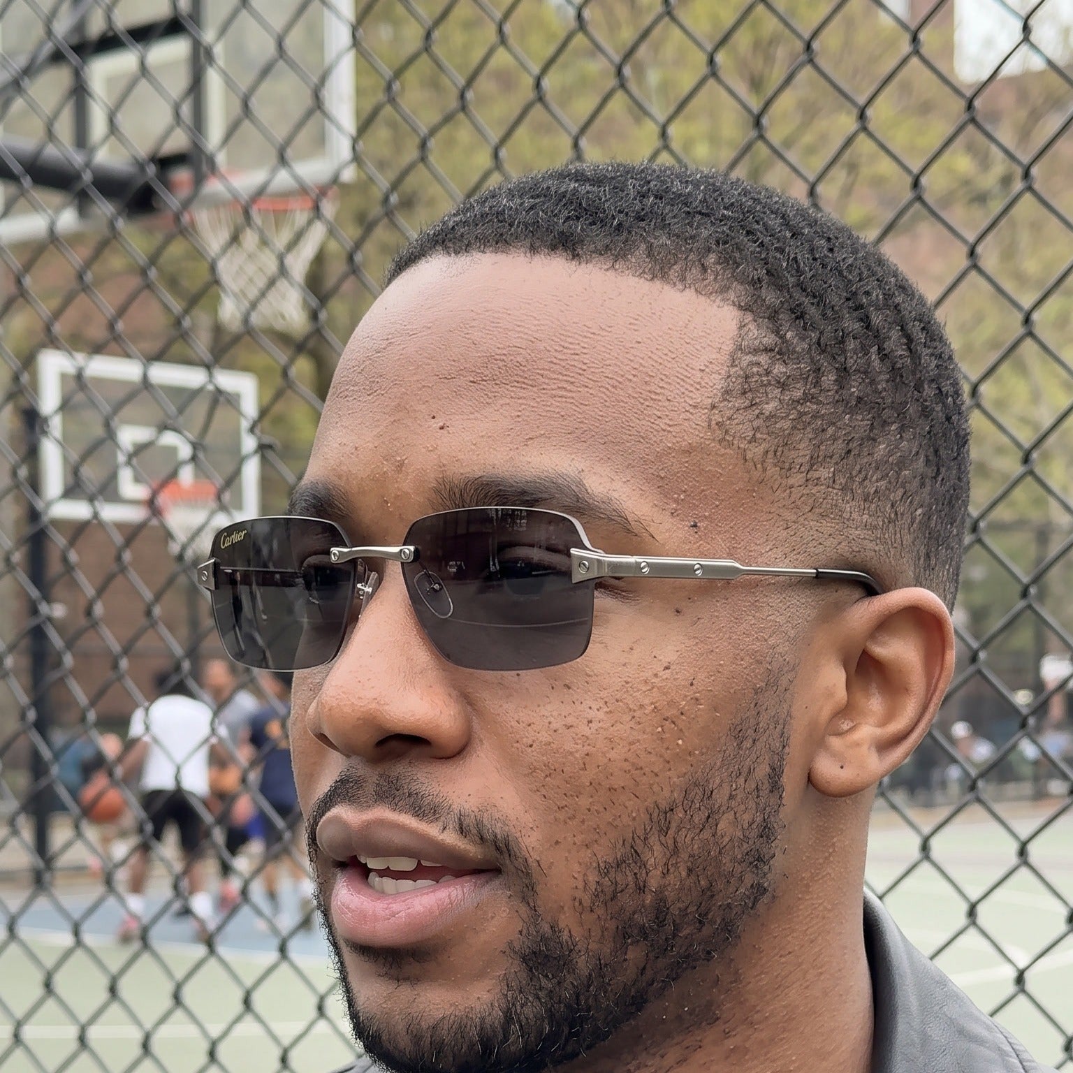 Man wearing the Big C Wire Sunglasses 58mm, solid grey lenses, Cartier eyewear