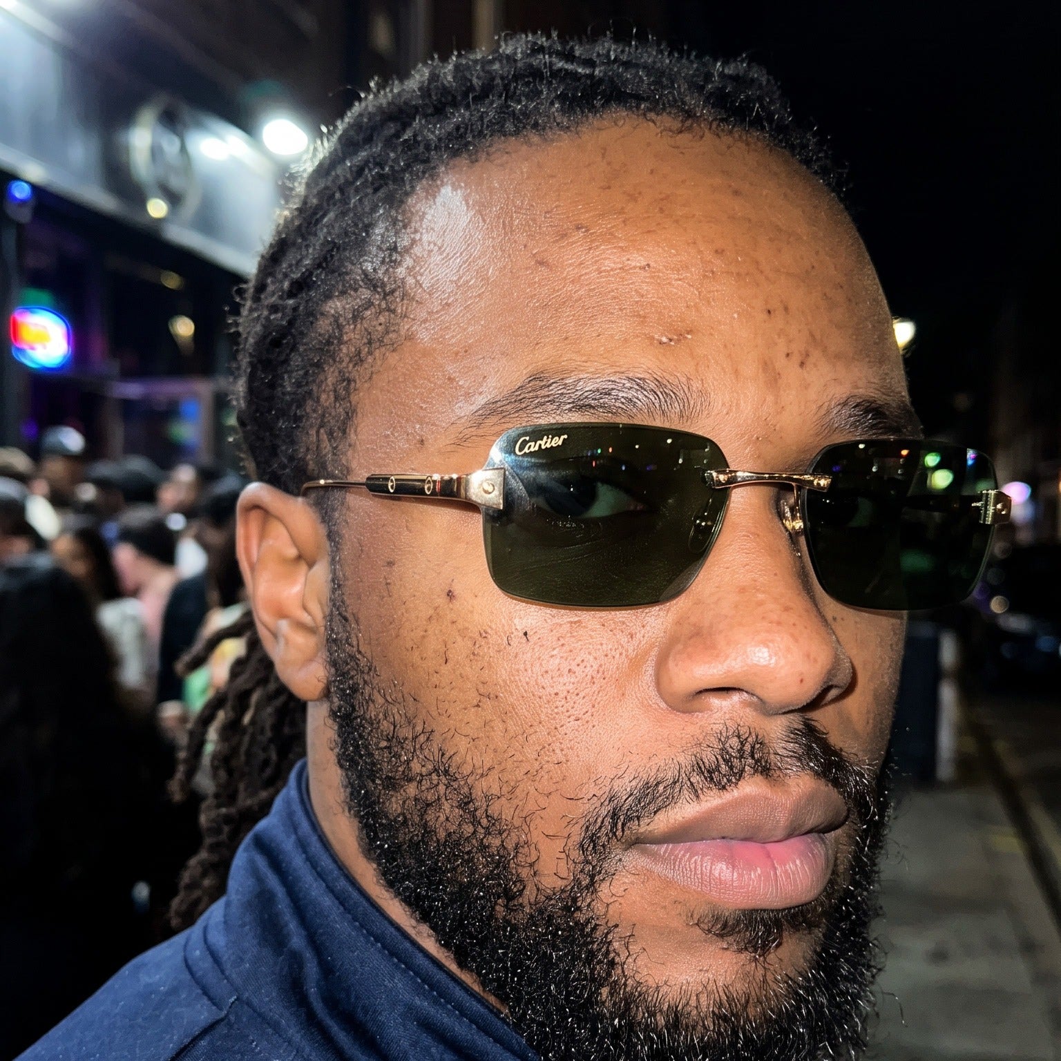 Man wearing the Big C Wires, solid green lenses, Cartier eyewear