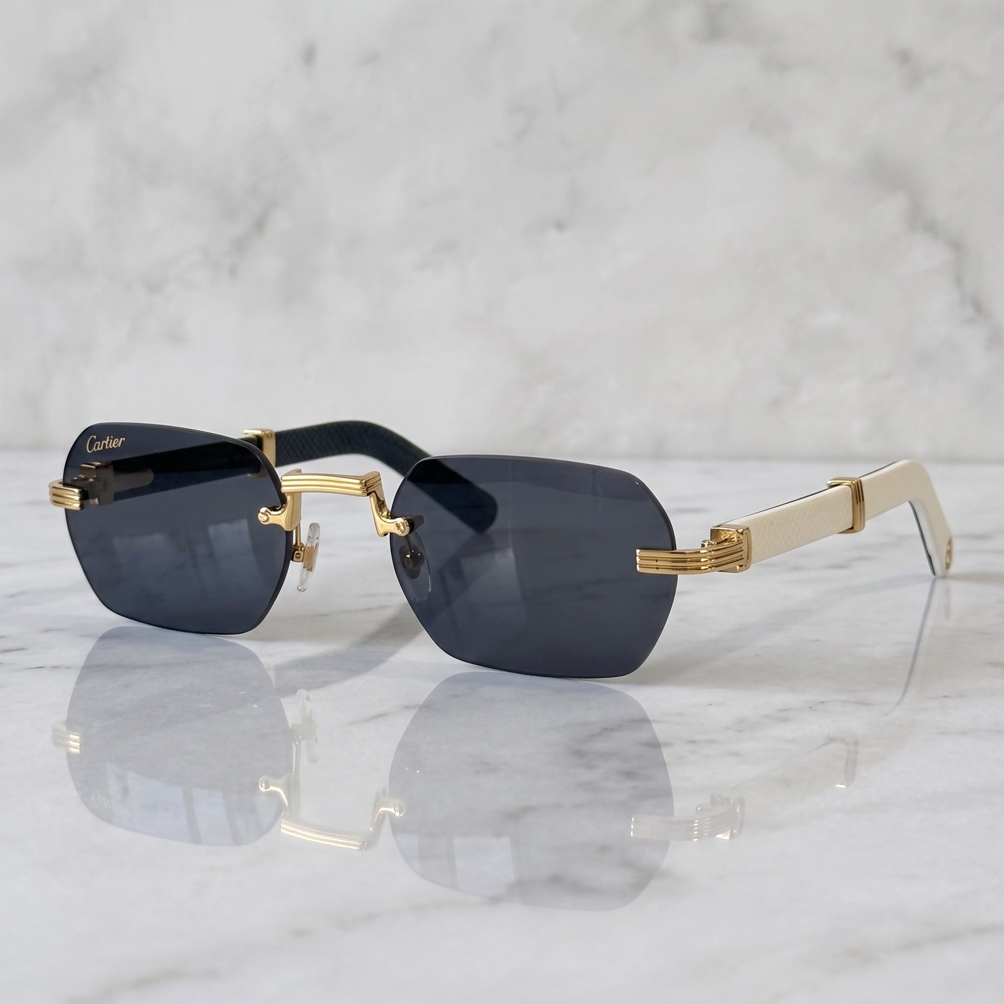 Rimless buffs Sunglasses Detroit style, solid dark blue lenses, Cartier eyewear