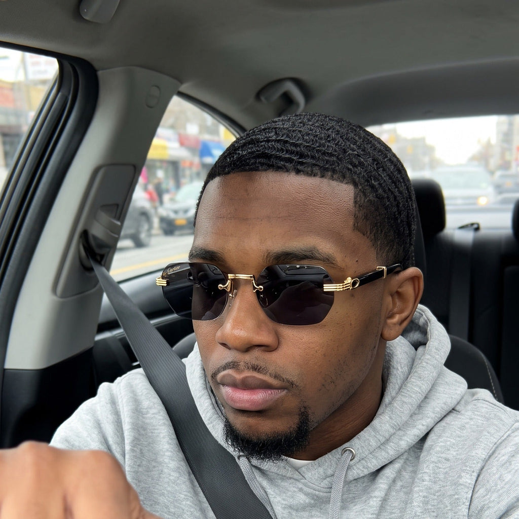 Man wearing the Rimless buffs Sunglasses Detroit style, solid grey lenses, Cartier eyewear