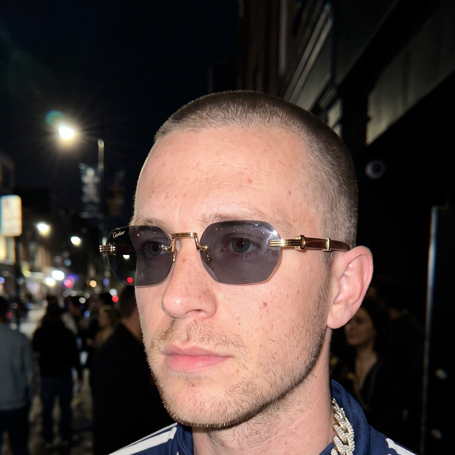 Man wearing the Rimless buffs Sunglasses Detroit style, solid grey lenses, Cartier eyewear