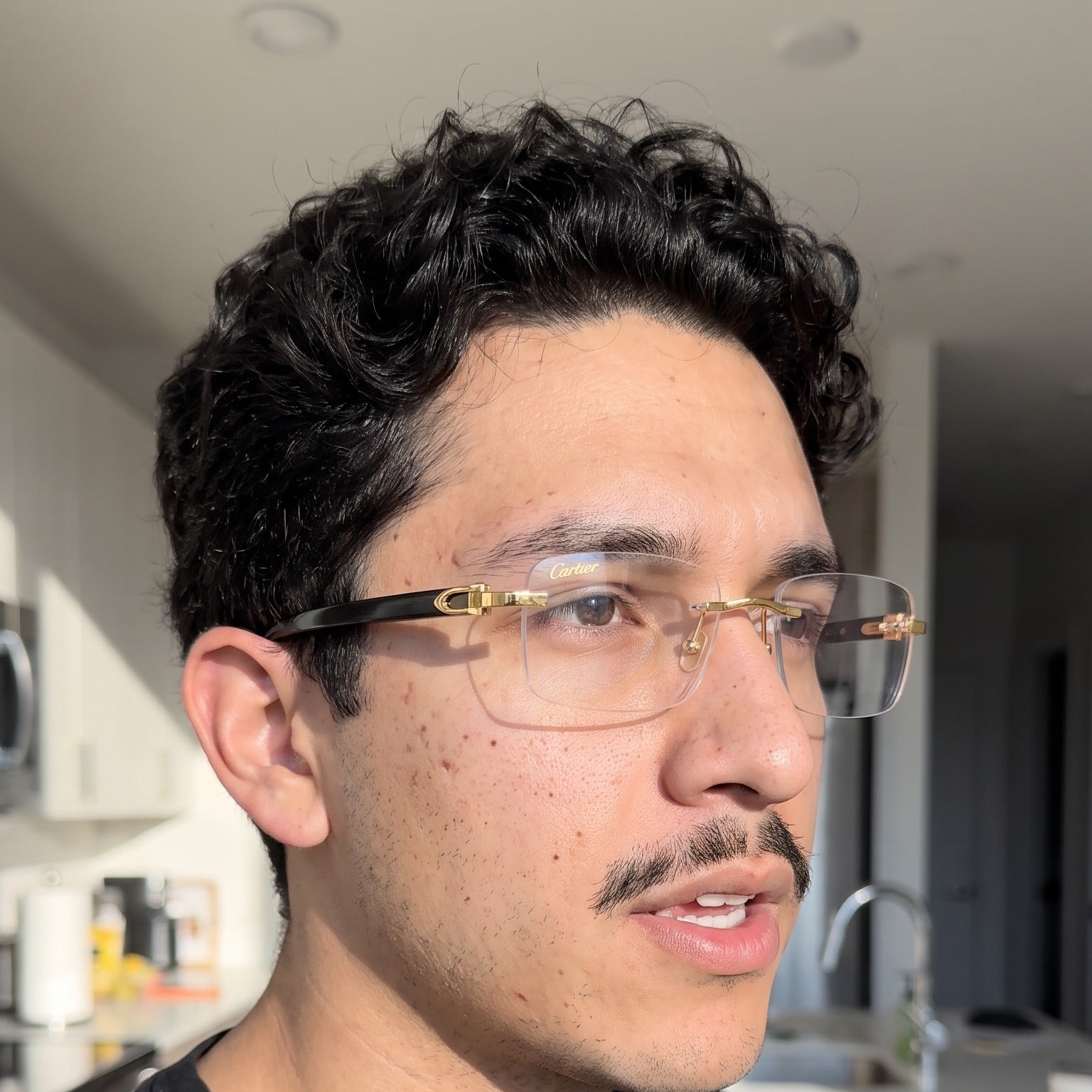 Man wearing the Rimless buffs Glasses, clear lenses, Cartier eyewear