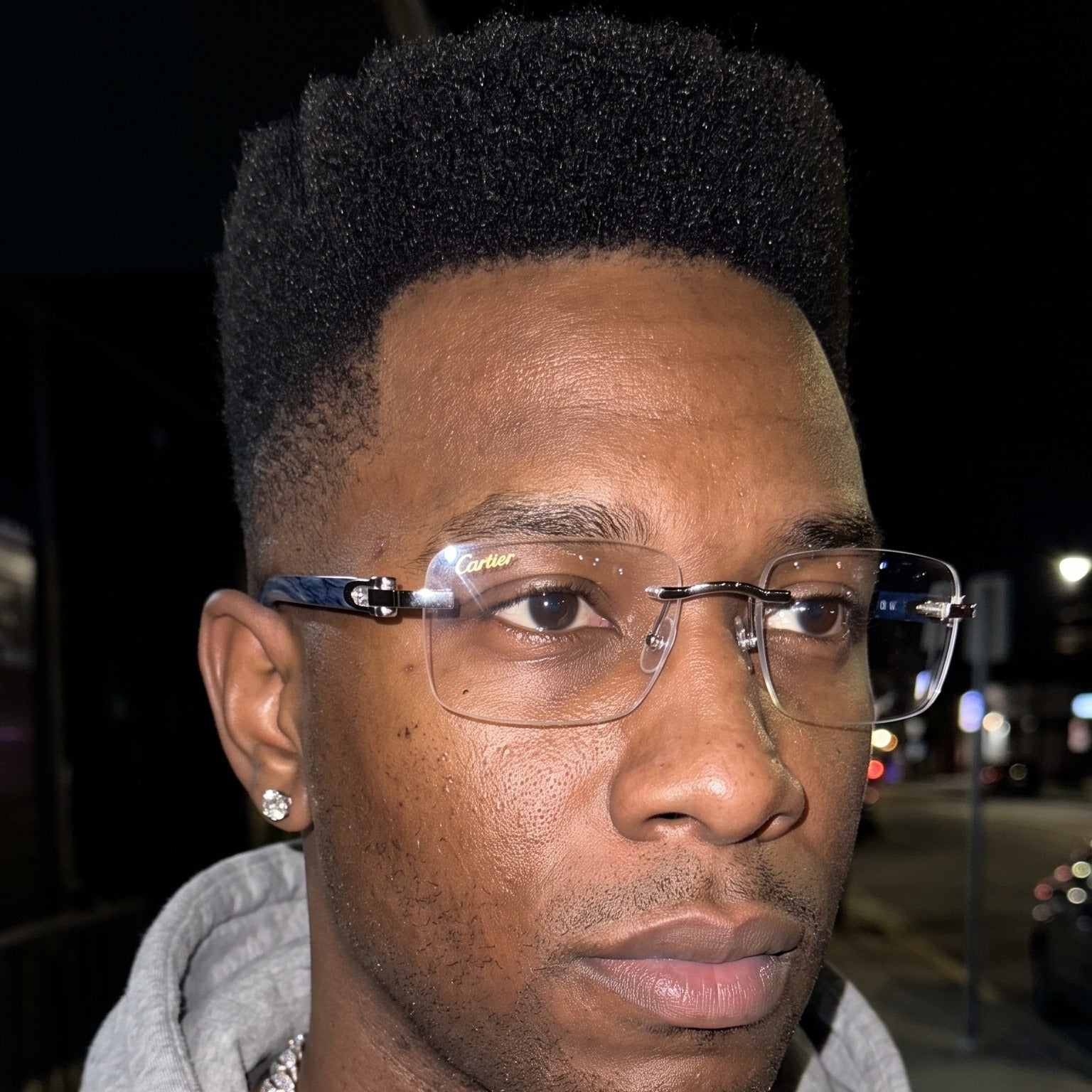 Man wearing the Rimless buffs Glasses, clear lenses, Cartier eyewear