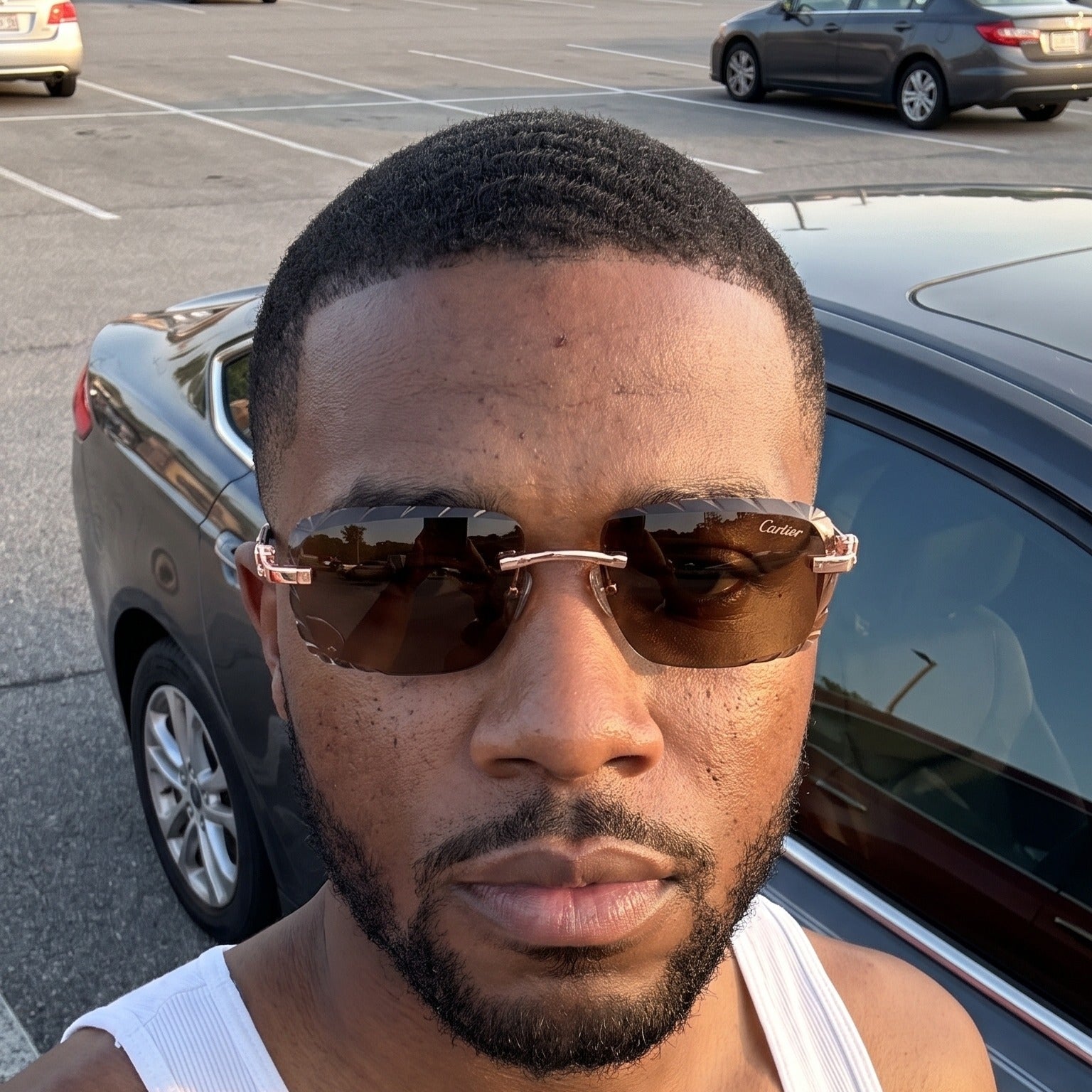 Man wearing the Diamond cut Big C Wires, brown lenses, Cartier eyewear