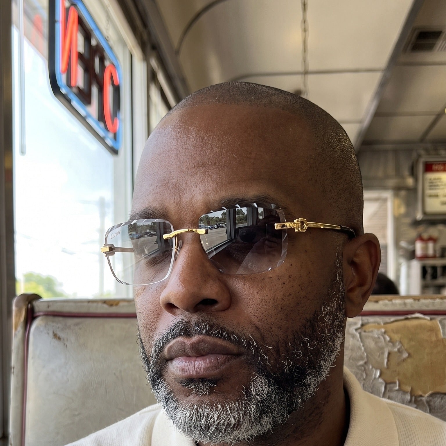 Man wearing the Diamond cut Big C Wires, transitional lenses, clear to grey, Cartier eyewear