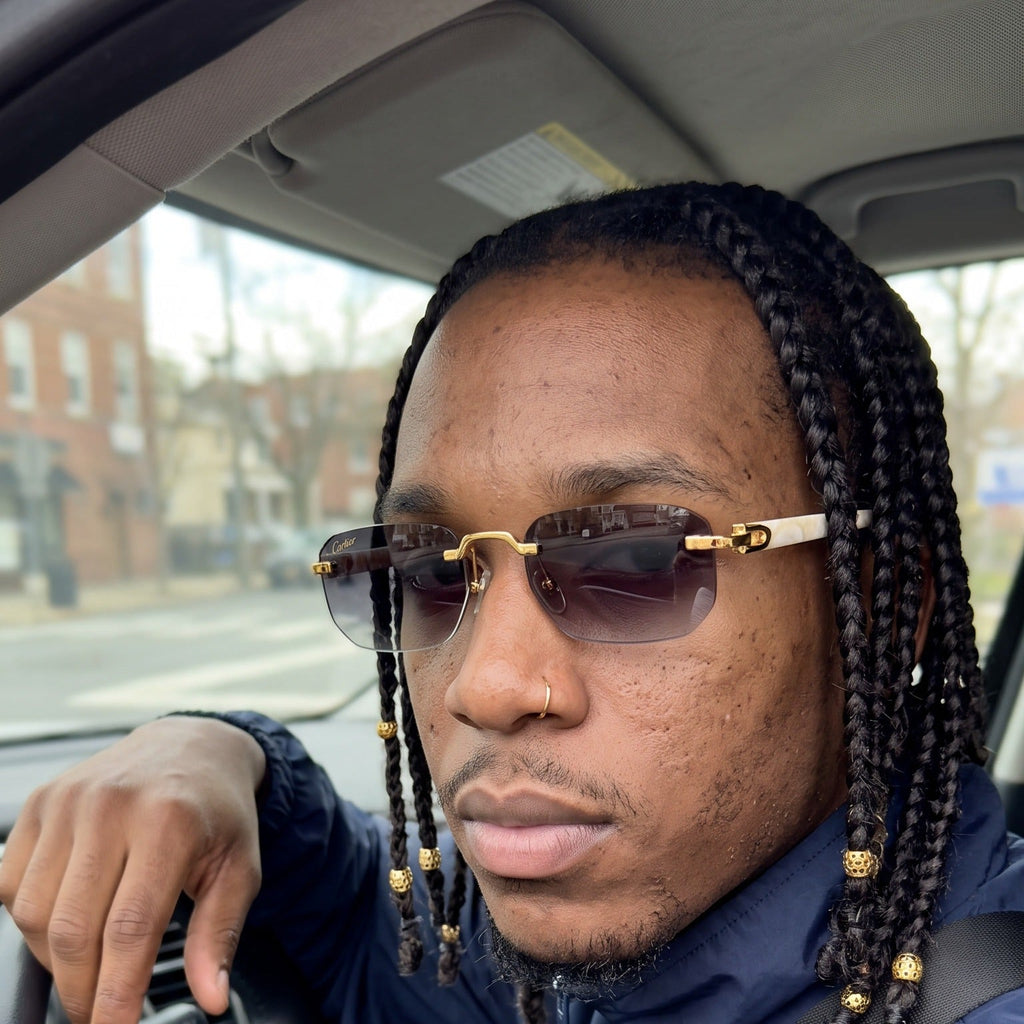 Man wearing the Rimless buffs Sunglasses, grey gradient lenses, Cartier eyewear
