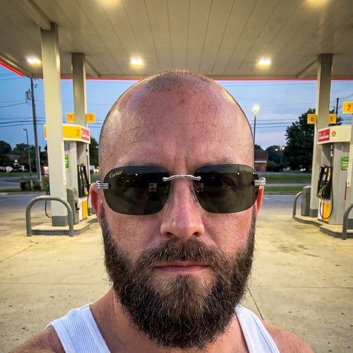Man wearing the Big C Wires, solid green lenses, Cartier eyewear