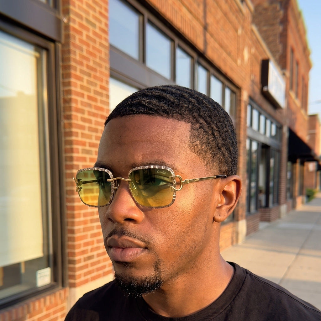 Man wearing the Iced out C wire glasses, yellow to green gradient lenses, Cartier eyewear