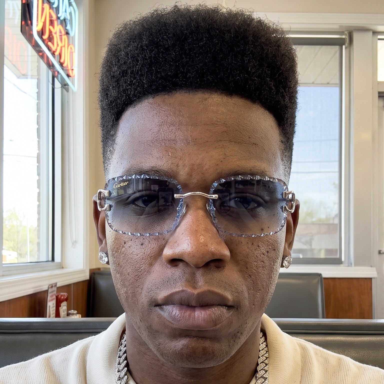 Man wearing the Iced out C wire glasses, blue gradient lenses, Cartier eyewear